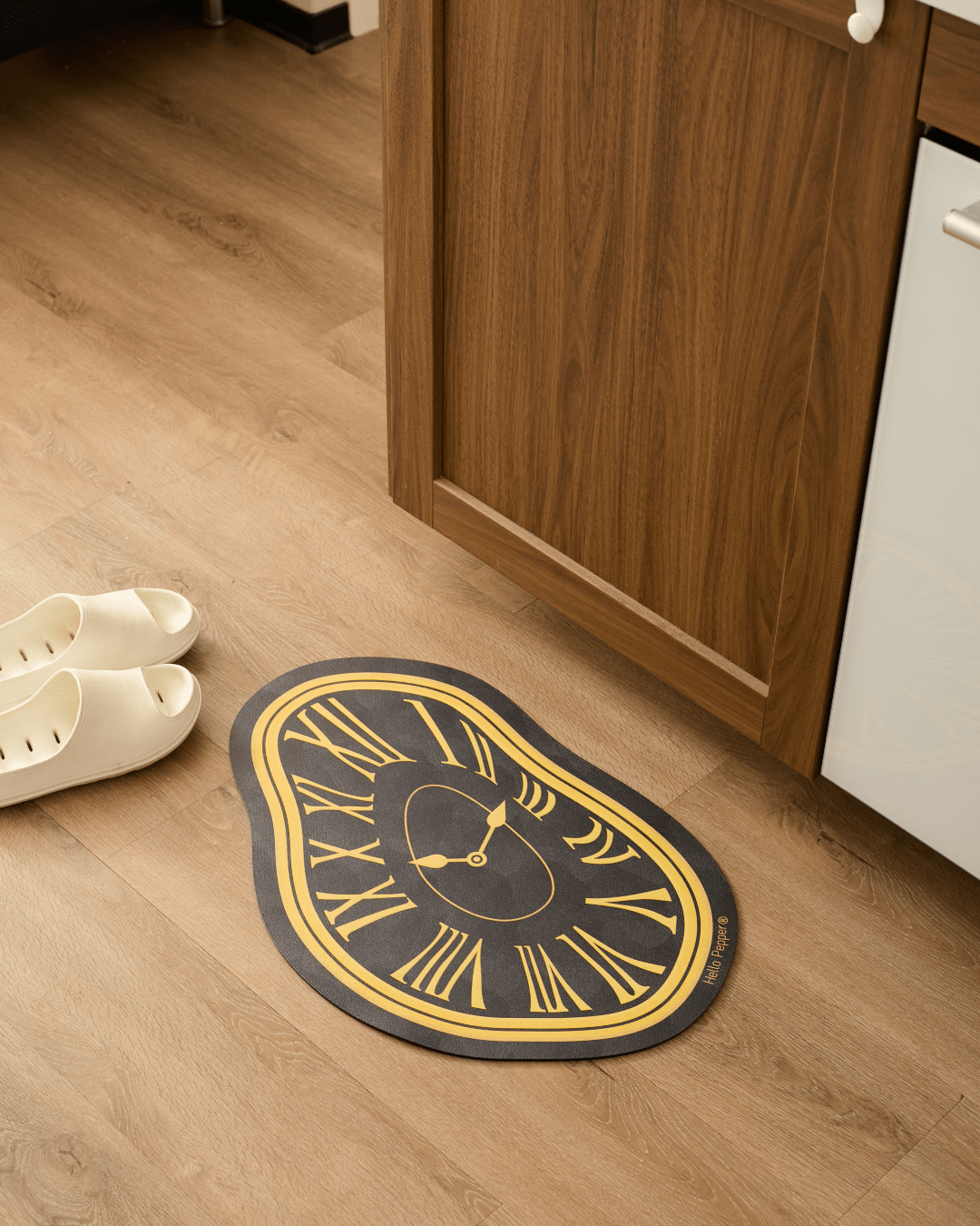 Black gold Dalí melting clock bath mat at bathroom entrance Hello Pepper